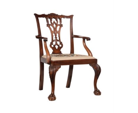 A CARVED MAHOGANY ARMCHAIRIN THE MANNER OF THOMAS CHIPPENDALE