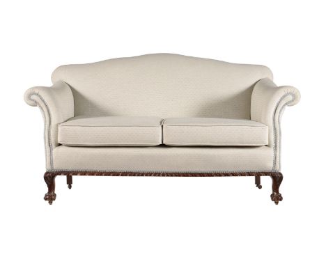 A MAHOGANY SOFA IN GEORGE II STYLECIRCA 1900 AND LATER UPHOLSTEREDWith arched back above the two removable cushions and carve