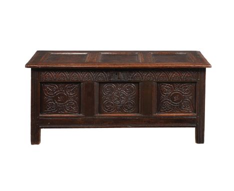 A CHARLES II PANELLED OAK CHESTCIRCA 1680With carved decoration, the three panel lid enclosing a large compartment65cm high, 