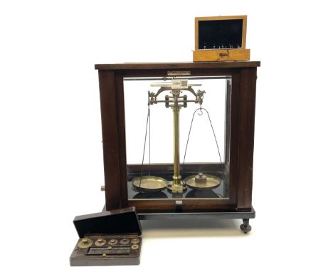 Set of laboratory balance scales by Reynolds &amp; Branson in mahogany case with upward sliding front door, two hinged side d