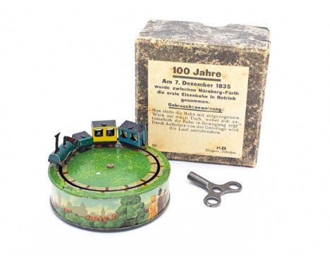 Karl Bub (Germany) 1935 tinplate clockwork "Der Adler" Train Set, tinprinted miniature item with detailed circular base, stea