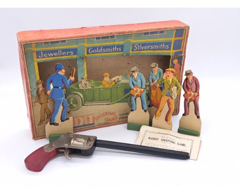 Chad Valley Bandit shooting game including four cardboard standees, wooden band shooting gun, instructions within Fair origin