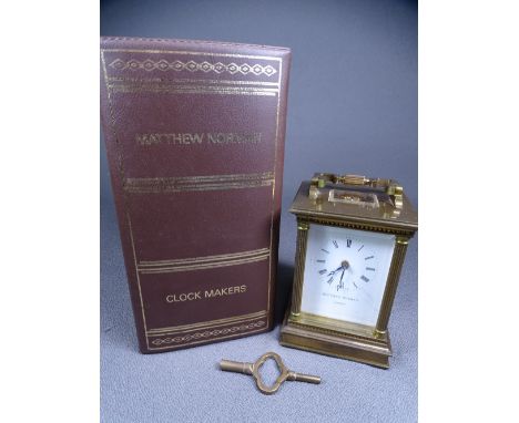 MATTHEW NORMAN BRASS ENCASED CARRIAGE CLOCK of fine quality with Corinthian corner columns, swing handle and striking movemen