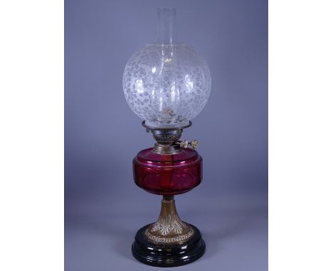 BRASS BASED OIL LAMP having a Cranberry glass reservoir and an etched floral bowl shade