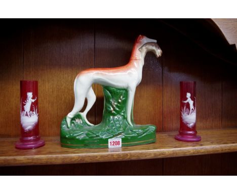 A Staffordshire style pottery greyhound, 29cm high; together with a pair of Mary Gregory style cranberry glass vases, 16cm hi