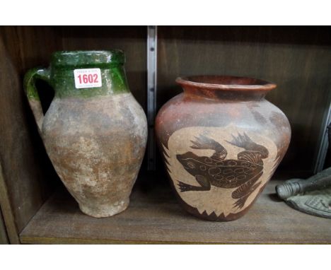 An old green glazed stoneware jug, 24.5cm high; together with another similar pottery vase. 