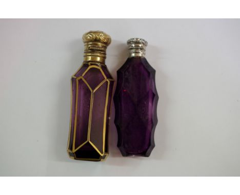 An amethyst faceted perfume bottle, having gilt decoration and metal hinged lid, 8.5cm; together with another smaller amethys