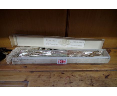 An old mother of pearl fan, boxed; and two parasols. Condition Report: Both ends broken and one strut missing.  Black parasol