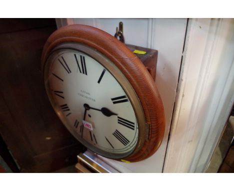 An oak circular fusee wall clock, the painted dial inscribed 'A J Faith, Chichester', 38cm diameter.