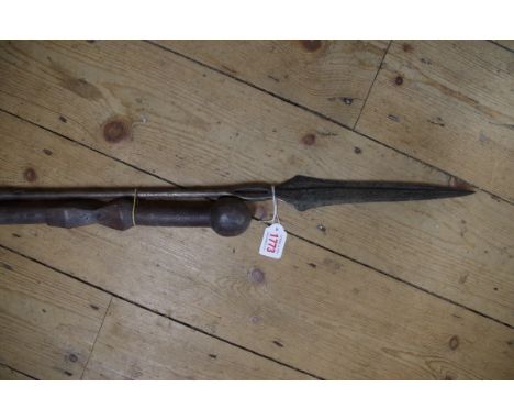 Ethnographica: a tribal spear; together with a hard wood club.