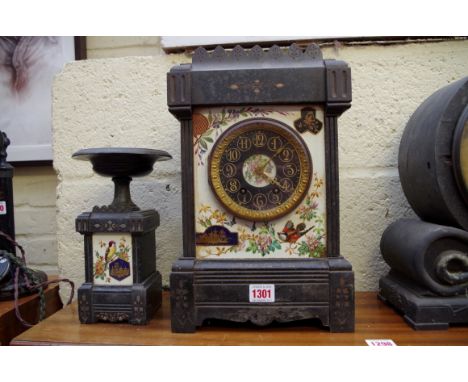 A slate and pottery mantel clock, 36.5cm high; with one matching side urn.   Condition Report:  Case: Chips to slate feet.  O