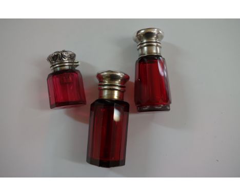 A Victorian ruby red scent bottle, having embossed silver hinged lid, by Charles May, Birmingham 1900, 4cm; together with two