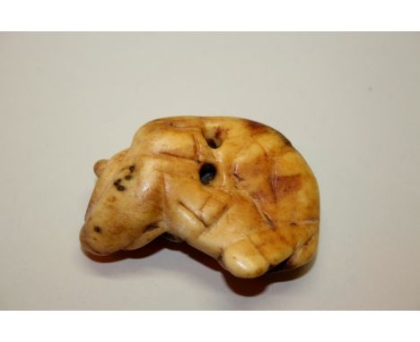 A Japanese carved stag antler netsuke of a recumbent ox, probably 18th century, 6cm wide.Provenance: Martyn R Bagley, 3rd Feb
