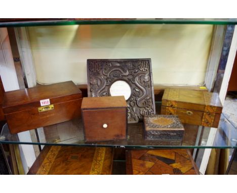Four various wooden boxes; together with an Eastern carved hardwood easel back frame.
