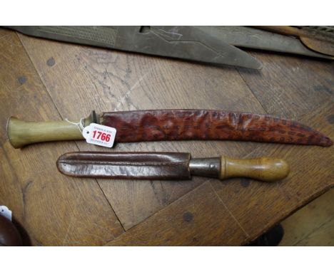 An antique horn handled dagger, with natural stitched scabbard; together with a vintage garden tool and leather sheaf. 