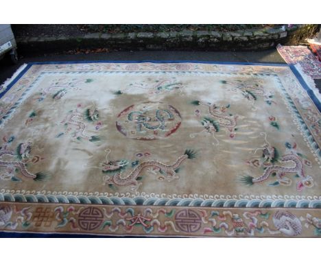 A large Chinese carpet, having central dragon medallion surrounded by a further eight dragons. 439 x 307cm. 