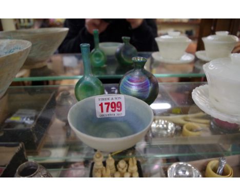 Two small iridescent glass bottle vases, largest 7.8cm high; together with a small studio pottery bowl, 7.5cm diameter