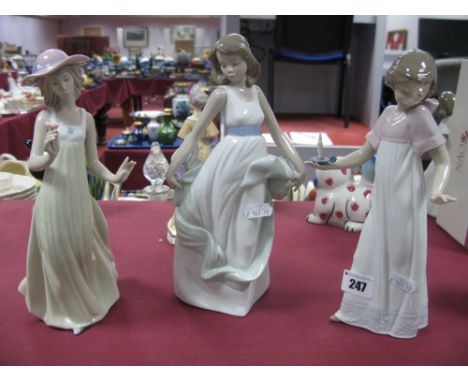 Three Nao Figures - Girl with Candle, Girl with Flower and Girl in the Wind, all boxed. (3)