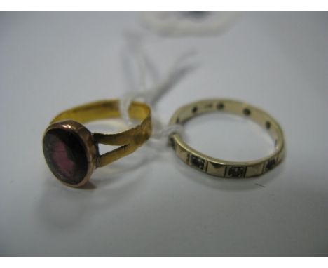 A Single Stone Ring, oval collet set, indistinctly stamped "22ct"; an eternity band stamped "9ct". (2)