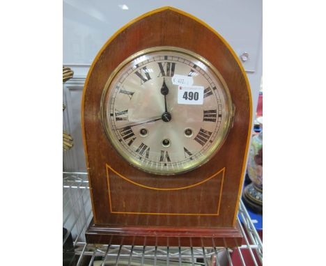 An Early XX Century Mahogany Inlaid Mantel Clock, with an arched top, silvered dial, Roman numerals, stepped plinth base on g