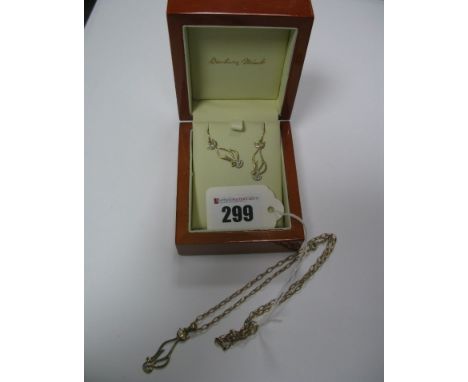 A Modern Openwork Cat Pendant, with inset eyes, stamped "375", on a chain; together with matching earrings. 