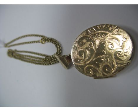 A Large 9ct Gold Oval Locket Pendant, leaf scroll engraved to the front, on a chain. 