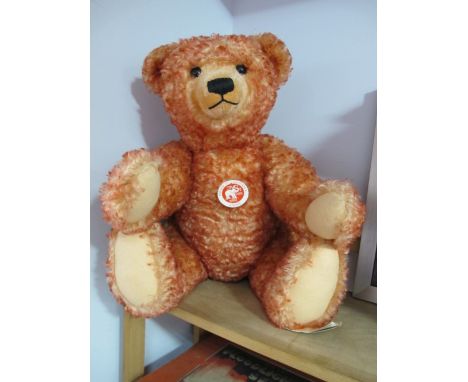 A Modern Steiff Classic Teddy Bear 'Sitting Down', red, with tags, 000218. Small hole noted on the bears left foot.