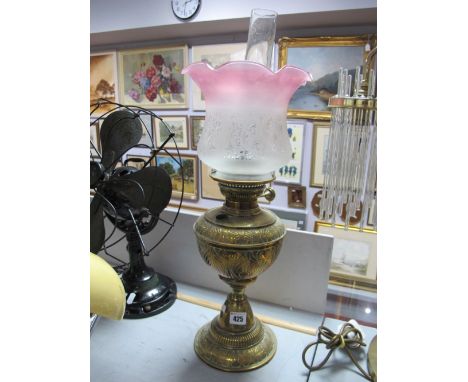 A Brass Oil Lamp, with cranberry tinted shade.
