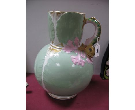 A XIX Century Bulbous Shaped Jug, with gilt highlights, light green ground, the handle in the form of a dolphin (with kite ma