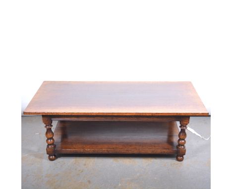 Modern oak coffee table, rectangular top, plain frieze, baluster turned legs, joined by a shelf, bun feet, 140x68cm, height 4