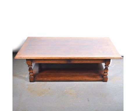 Modern oak coffee table, rectangular top with moulded edge, plain frieze, baluster turned legs joined by a shelf, 150x80cm, h