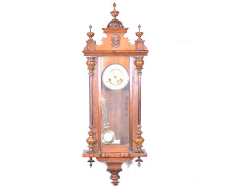 A walnut cased Vienna wall clock, enamelled chapter ring, spring-driven movement, 104cm; and a small Vienna style wall clock.