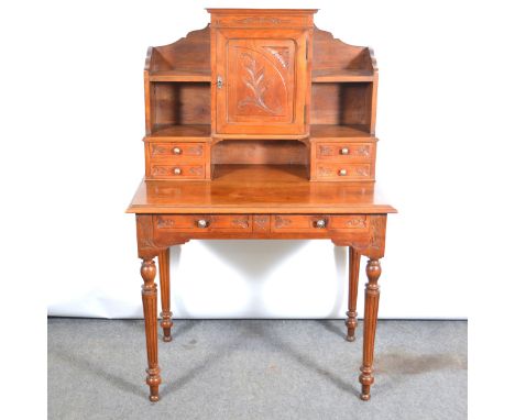 An Edwardian mahogany&nbsp;bonheur du jour table, two draws, central cupboard, raised back with shelf and draws to sides, flu