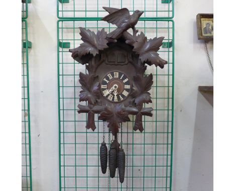 A vintage Black Forest wall hanging musical cuckoo clock 