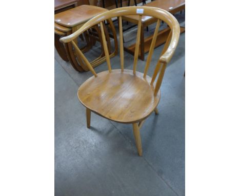 An Ercol Blonde elm and beech 338 model cowhorn fireside chair 
