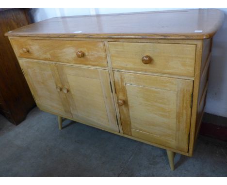 An Ercol Blonde elm and beech Windsor sideboard 