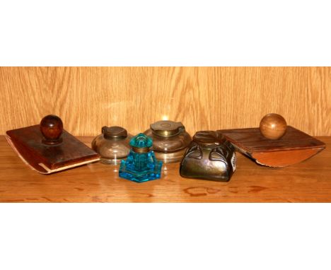 An Art Nouveau inkwell, three further inkwells and two blotters.