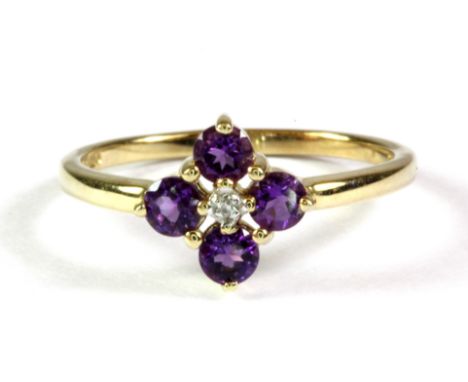 A 9ct yellow gold amethyst and diamond set flower shaped ring, (L.5).