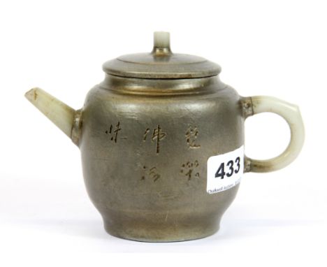 A Chinese pewter overlaid Yixing terracotta teapot with jade spout and handle, H. 11cm.