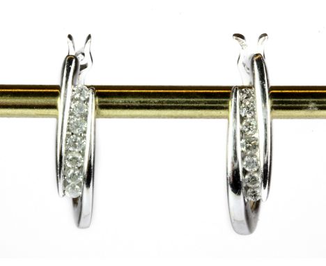 A pair of 9ct white gold diamond set earrings.