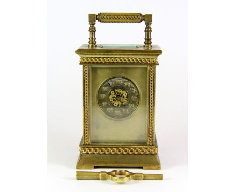 An early 20th century French gilt brass carriage clock with key, H. 14cm.