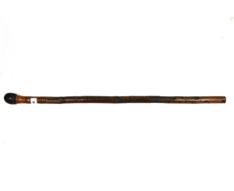 An early 20th century Japanese carved bamboo walking stick, L. 78cm.