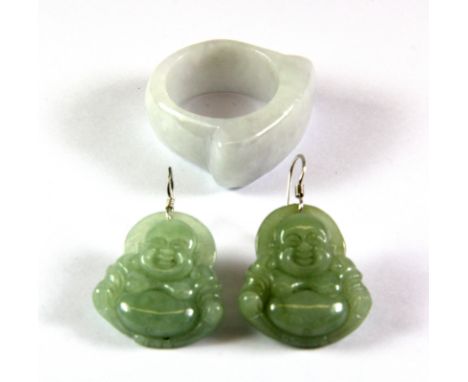 A jade ring and a pair of carved jade Buddha drop earrings.
