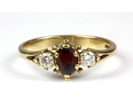 A 9ct yellow gold garnet and diamond set ring, (Q).