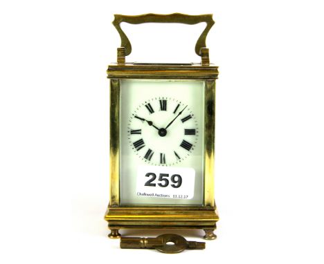 A gilt brass carriage clock with key, H. 15cm.