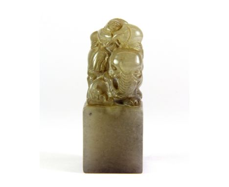 A mid 20th century Chinese carved grey soapstone seal mounted with a boy on an elephant, H. 8cm. Prov. Ignatious collection.