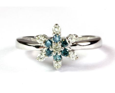 A 9ct white gold snow flake shaped ring set with blue and white diamonds, (M).