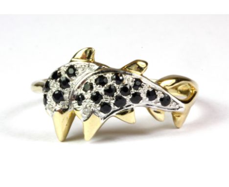 A 9ct yellow and white gold sapphire set dolphin ring, (P.5).