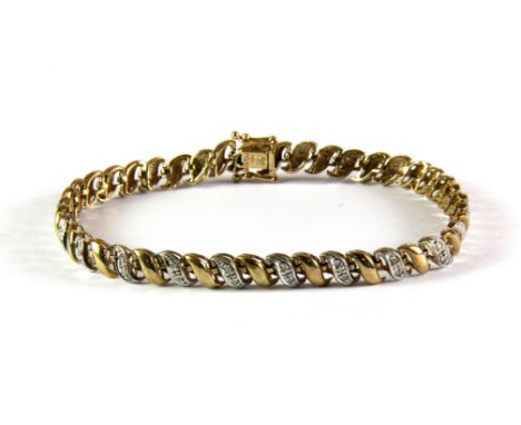 A 9ct yellow gold diamond set bracelet.