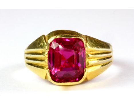 A gentleman's yellow metal (tested 22ct gold) ring set with a cushion cut ruby, (R).